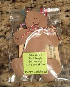 a packaged package with a christmas teddy bear on it's side and a note attached to the back