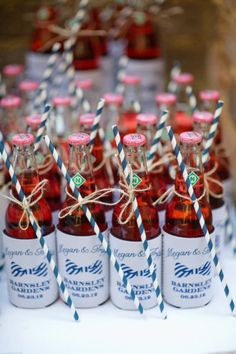 small bottles with straws tied to them sitting on a table