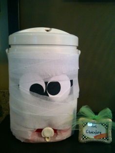 a plastic bucket with a face on it next to a candy bag