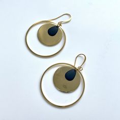 Round gold earrings with hoops and and art deco feel.  These elegant earrings feature a shiny gold plated disc, black metal teardrop all enclosed in a gold plated hoop.  The earrings are finished with a gold plated ear wire.  I have a similar design with the black/gold colours reversed out Drop approx 55mm, inner disc is 25mm in diameter. The disc is gold plated metal (brass)  All Unherdlondon designs come beautifully packaged in a brand gift box or organza bag Perfect earrings for everyday or special occasions.   Gift for self - gift for her - special occasion earrings - unique one of a kind designs - made with love - elegant art deco earrings Free worldwide shipping (selected countries)  Please note the display bust is not full size so the earrings look bigger than they would in real lif Nickel-free Gold Open Circle Earrings, Gold Open Circle Nickel-free Earrings, Gold Nickel-free Open Circle Earrings, Gold Brass Open Circle Jewelry, Gold Metal Nickel-free Teardrop Earrings, Gold Dangle Jewelry With Black Enamel, Black Enamel Hoop Earrings For Gift, Black Enamel Hoop Earrings As Gift, Gold Hoop Earrings With Black Enamel For Gift