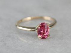 Truly all about the stone, this traditional, yellow gold mounting frames the stone perfectly while holding it securely with four split prongs. The center pops with an amazing pink color and is adorned with an expertly cut pink sapphire. Metal: 14K Yellow Gold Gem: Pink Sapphire 1.17 Carats Gem Measurements: 5 x 7.5 mm, Oval Ring Size: 5.75 Marks: "14" Stamped on the inside band Formal Pink Birthstone Ring With Gemstone, Pink Birthstone Ring With Gemstone For Formal Occasions, Pink Gemstone Birthstone Ring For Formal Occasions, Formal Pink Gemstone Birthstone Ring, Classic Pink Ruby Ring With Center Stone, Heirloom Pink Ring With Center Stone, Formal Pink Ruby Ring With Brilliant Cut, Pink Fine Jewelry Birthstone Ring For Formal Occasions, Formal Pink Brilliant Cut Ruby Ring