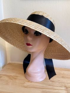 This straw style Audrey Hepburn oversized natural wheat straw made from Milan braid sewn straw Bell Brim lampshade style hat is trimmed with a removable 2 1/2 inch double sided black satin ribbon band and bow, other ribbon choices are white and cream. The brim has a  5 1/2  inch brim with a 4 inch crown and will fit up to 22 3/4 inch head size. The inside band has a sizing cord to adjust the head size. NOTE: Please check the head size before purchase, I am happy to answer any questions you may have. There will be a 20% restocking fee for all returned hats. Adjustable Short Brim Straw Hat For Church, Adjustable Brimmed Straw Hat For Church, Cream Straw Bucket Hat, Natural Woven Straw Hat For Kentucky Derby, Natural Straw Hat For Kentucky Derby, Adjustable Wide Brim Boater Hat For Church, Natural Straw Hats For Kentucky Derby, Cream Straw Boater Hat For Kentucky Derby, Beige Straw Boater Hat For Kentucky Derby