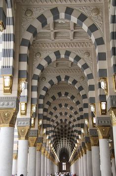 the inside of a building with columns and arches