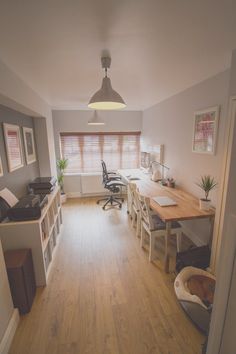 an office with wooden floors and white walls