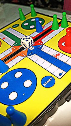 a close up of a board game with dices and markers on the board,