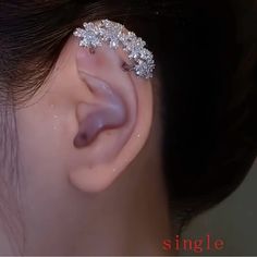 a close up of a person's ear with some piercings on it