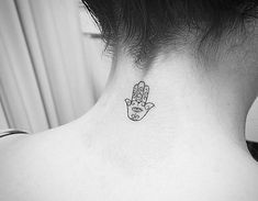 a woman with a small tattoo on her neck