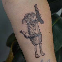 a person with a dog tattoo on their arm holding a book and an ax in his hand