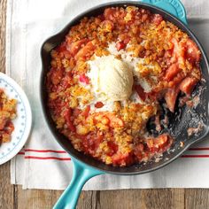 a skillet filled with food next to a bowl of ice cream