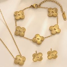 3 Piece Gold Clover Set. Double-Sided Necklace And Bracelet Stainless Steel 18 Kt Gold Plated Hypoallergenic Water Resistant Alhambra Style. Yellow Gold Flower-shaped Jewelry, Dainty Metal Jewelry In Flower Shape, Dainty Metal Flower Shaped Jewelry, Dainty Metal Flower-shaped Jewelry, Elegant Flower Shaped Clavicle Chain Jewelry, Elegant Flower-shaped Clavicle Chain Jewelry, Dainty Flower-shaped Metal Jewelry, Tarnish Resistant Stainless Steel Jewelry For Party, Gold Plated Flower Shaped Jewelry With Matching Earrings