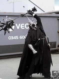 a man dressed as darth vader holding an umbrella