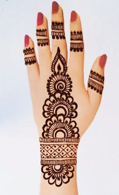 a woman's hand with henna tattoos on it