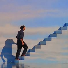 a man standing on top of a stair case in front of a blue sky with clouds