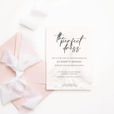 the perfect dress bridal suite is on display next to an envelope with a bow