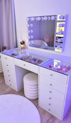 a white vanity with purple lights on it and a mirror in the corner next to it