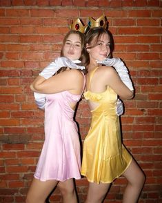 two women dressed in costumes posing for the camera