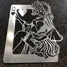 a metal playing card with a woman holding a heart on the front, and a diamond in the back