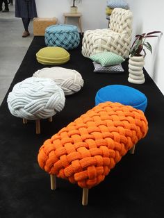 several knitted chairs and stools are on display