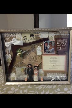 a wedding photo frame with two bride and groom figurines