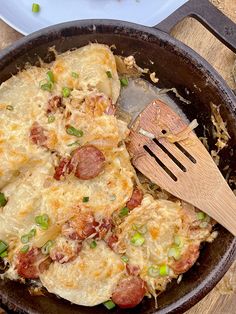 a skillet with some food in it and a spatula on the table next to it