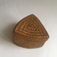 a brown basket sitting on top of a white table