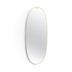 an oval shaped mirror on the wall with a pink frame and metal bar at the bottom