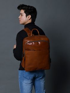 Make a bold statement with this head-turning Italian brown leather backpack that radiates confidence and style. The glossy finish enhances its vibrant color, creating a mesmerizing and eye-catching accessory. The sleek design and luxurious feel of the leather makes it a standout piece in any fashion ensemble, promising to elevate your look with a touch of glamour. Whether you're navigating city streets or making a grand entrance at an event, this bold and eye-catching brown leather backpack is t Waxed Canvas Bag, Brown Leather Backpack, Duffel Bag Backpack, Trolley Bags, Bag Suitcase, Briefcase For Men, Vegan Bags, Buffalo Leather, Grand Entrance