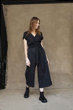 "Linen Jumpsuit -- a style staple to have in your wardrobe. Similar to a dress, but you don't have to worry about blowing up. The length is just above the ankle, so pants are wide as sort of culottes but not too long to be swallowed. Lightness is sophisticated by flirty V-neck and gentle pleats and balanced with short sleeves. Such a wrap linen jumpsuit is designed to highlight the feminine feature of yours. For your comfort, it is provided with an adjustable waist belt and functional side pocke Spring Linen Jumpsuits And Rompers For Work, Chic Linen Jumpsuits And Rompers With Short Sleeves, Fitted Short Sleeve Jumpsuits And Rompers With Tie Waist, Fitted Short Sleeve Jumpsuit With Tie Waist, Fitted Linen Jumpsuits And Rompers For Spring, Spring Fitted Linen Jumpsuits And Rompers, Fitted Black Jumpsuits And Rompers With Tie Waist, Black Fitted Jumpsuit With Tie Waist, Elegant Relaxed Fit Jumpsuit In Solid Color