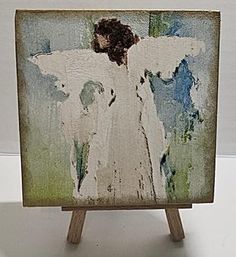 an angel painted on a wooden easel