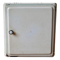 an old white box with a black knob on it's left side is shown