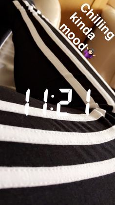 a black and white striped bag with the numbers 511 on it sitting on top of a bed