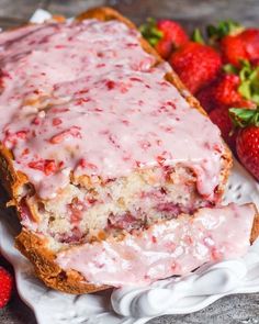 strawberry bread with icing and strawberries on the side