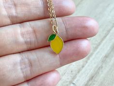 This dainty lemon necklace is made of the following: (1) gold plated yellow and green epoxy lemon charm (13.5 x 9mm) (2) gold plated or 14KGF chain ✏️ Please choose your desired plating of chain ✏️ Please choose the length of the chain (the length includes clasp and findings). ❣️ If you are unsure about which length to choose , please leave me a note to request an extension chain to be added to the chain at check out. 🍋 EARRINGS 🍋 https://www.etsy.com/listing/1036952369 【BEFORE PURCHASE, PLEAS Cute Yellow Necklace For Gifts, Cute Yellow Necklace For Gift, Dainty Yellow Necklace For Gift, Dainty Yellow Necklace For Gifts, Dainty Yellow Charm Necklace For Gifts, Yellow Novelty Adjustable Jewelry, Yellow Enamel Earrings, Yellow Enamel Jewelry With Charms, Lemon Necklace