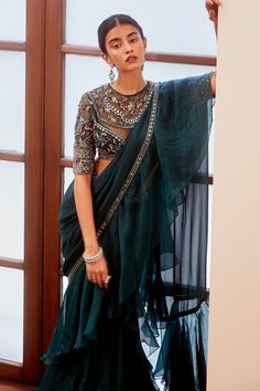 Teal green pre-draped saree with embroidered border and ruffle detailing. Comes with sheer neckline blouse.
Component: 2
Embroidered
Neckline: Round
Sleeve Length: Elbow
Fabric: Georgette
Color: Green
Mirror, resham, cutdana and sequin embroidery
Embroidered blouse
Sheer neckline and back - Aza Fashions Tussar Silk Kurta, Ruffled Saree, Gopi Vaid, Silk Kurta Set, Indian Bridesmaids, Ruffle Saree, Drape Saree, Saree Designs Party Wear, Indian Dresses Traditional