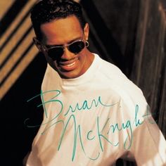 a man wearing sunglasses and a white shirt with the words bran mcknight on it