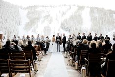 a couple getting married in front of a snowy mountain