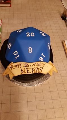 a blue and black birthday cake on top of a table