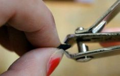 a close up of a person holding a pair of scissors