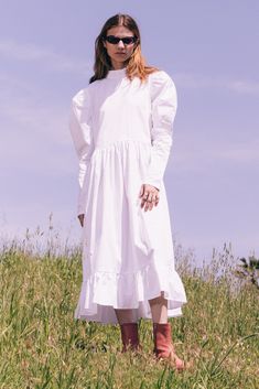 Our designer's favorite dress this season, the Honey Ryder. Featuring the cutest ruffle neck and voluminous puff sleeves. Plus a shirred waistline and ruffle hem for added volume in the skirt. White, 100% Cotton Poplin Black, 100% Cotton Poplin White & Black, 100% Cotton Gingham Seersucker Descano Gardens Print, 96% Polyester 4% Spandex Ruffle Neck Boxy Shape Center Back Spaghetti Tie Closure Voluminous Leg-O-Mutton Long sleeves Shirred Waistline Shirred Ruffle Hem Volume Shirring Side Pockets S Honey Ryder, Garden Print, Skirt White, Small Batch, Favorite Dress, Ruffle Hem, Cotton Poplin, Puff Sleeves, The Cutest