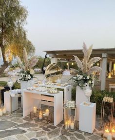 an outdoor wedding setup with candles and flowers