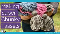 a woman holding two crocheted hats with tassels on them and the words making super chunky tassels