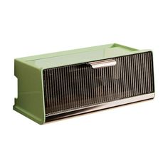 an old fashioned green radio sitting on top of a white surface with no people around it