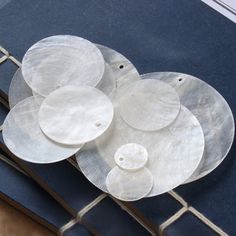 four white plates sitting on top of a blue table cloth next to a metal rack