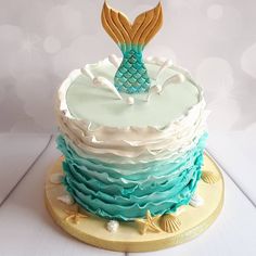 there is a cake that looks like a mermaid tail on top of the cake,