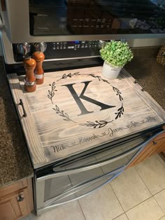 a monogrammed kitchen mat with the letter k on it in front of an oven