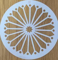 a paper cut out of a flower on top of a wooden table