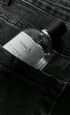 an empty bottle sitting in the back pocket of a pair of jean pants with a label on it