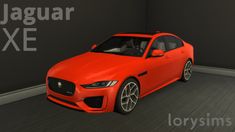 a red car is parked in a room with black walls and wood flooring that says jaguar xe