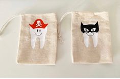 two bags with cartoon tooth and pirate hat on them