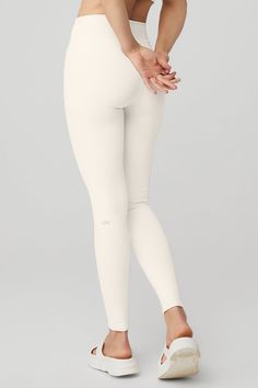 An on-trend high waistline on our classic Airbrush legging. Spotted on basically every it-girl, the High-Waist Airbrush Legging has an on-trend rise and all the best assets of the classic version, like no side seams and a yogi-tested fit that lifts and sculpts. Sculpts, smooths & lifts! No side seams & flat-locked seams for extra comfort Designed & uniquely fit to flatter every size Wear-tested by our in-house team for the perfect fit High-Waist Airbrush Legging in Ivory, Size: Medium | Alo Yoga Ivory Leggings, Cream Leggings, Liquid Leggings, Tank Top Bras, White Leggings, Black Flare, It Girl, Alo Yoga, Bra Women